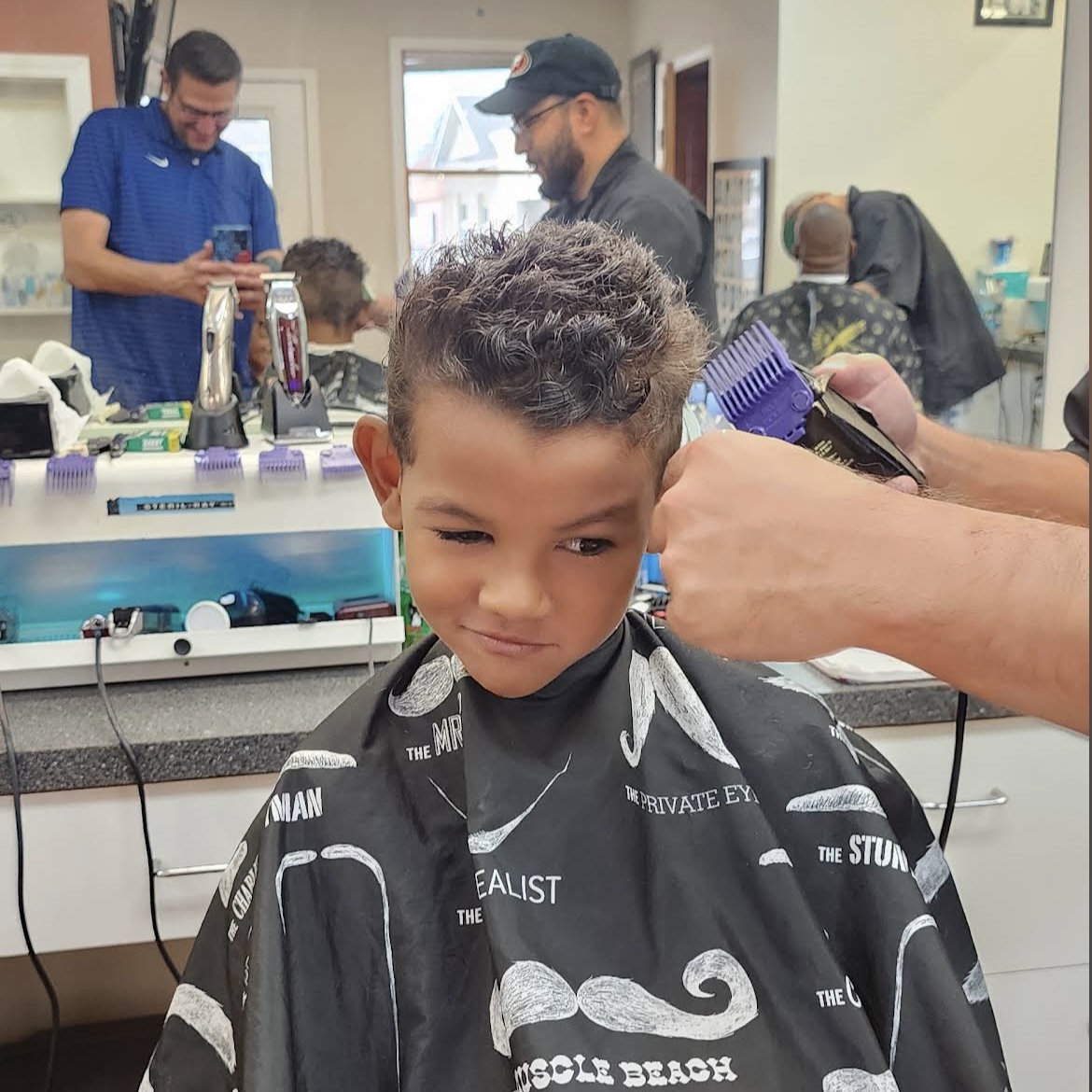 Smiling kid getting a fresh haircut